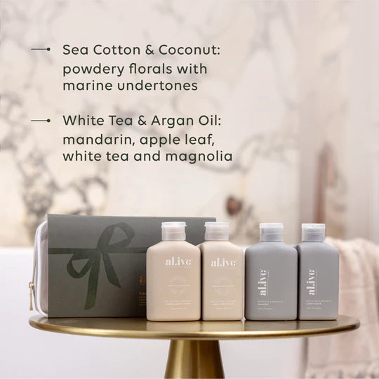 al.ive body Holiday Travel Pack featuring Sea Cotton & Coconut Wash and Lotion and White Tea & Argan Shampoo and Conditioner in a premium Stone and Steel Blue travel bag.
