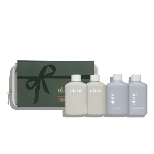 al.ive body Holiday Travel Pack featuring Sea Cotton & Coconut Wash and Lotion and White Tea & Argan Shampoo and Conditioner in a premium Stone and Steel Blue travel bag.

