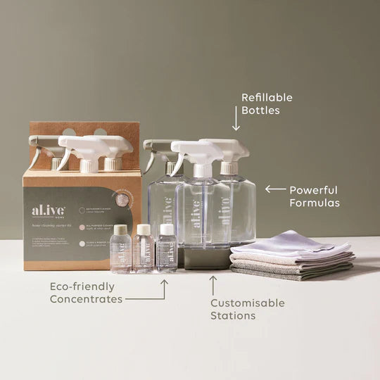 The Al.ive Home Cleaning Starter Kit, featuring three refillable 450ml bottles, each paired with 50ml cleaning concentrates for All Purpose, Bathroom, and Glass & Mirror cleaning. The kit includes three microfibre cloths, three bottle stations with connectors for customizable organization, and a sleek, modern design displayed on a clean countertop. The eco-friendly packaging is made with 30% post-consumer recycled plastic, showcasing a sustainable and effective cleaning solution.
