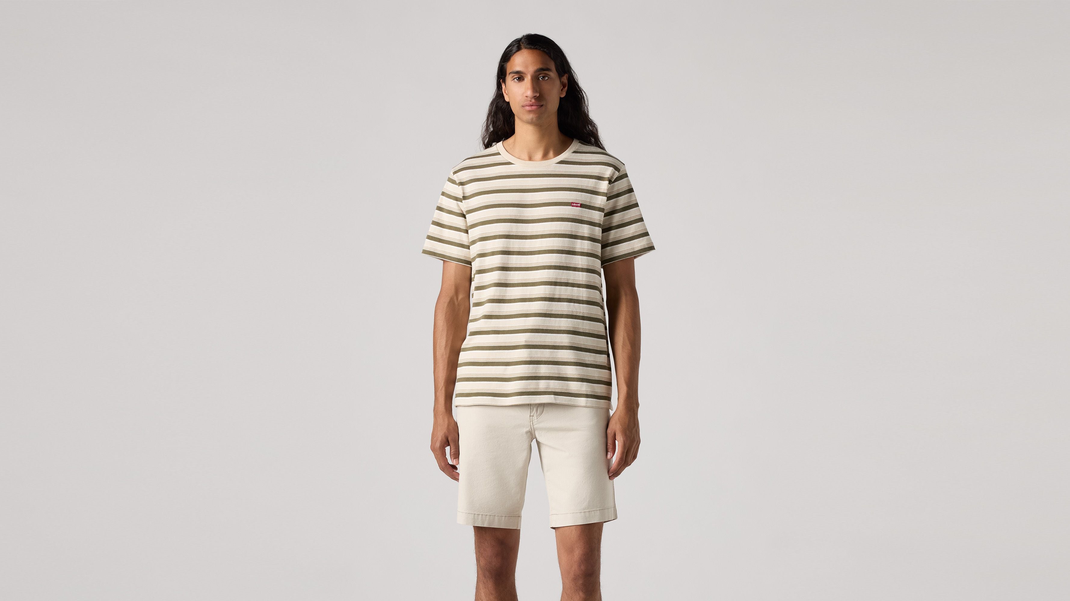 Levi's Men's Housemark Shirt in cream and green stripes, featuring a relaxed fit, short sleeves, and crew neck. Made from 100% cotton for soft, all-day comfort with a subtle logo detail.