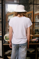 Ice Tee in white marle featuring a signature star print, relaxed fit, crew neckline, short sleeves and raw-edge hem.