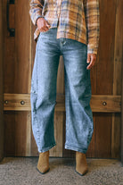 Mid-blue denim barrel-leg jeans with a relaxed fit, cuffed hem, side panel detailing, contrast stitching, and 5-pocket design.