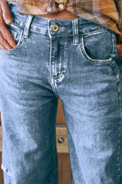 Mid-blue denim barrel-leg jeans with a relaxed fit, cuffed hem, side panel detailing, contrast stitching, and 5-pocket design.