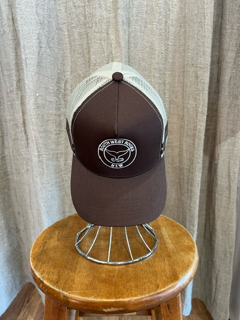 Rocks Hat in brown and white featuring a whale tail design on the front, snapback closure, and breathable mesh sides for a comfortable, adjustable fit.