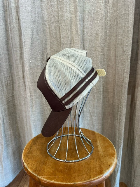 Rocks Hat in brown and white featuring a whale tail design on the front, snapback closure, and breathable mesh sides for a comfortable, adjustable fit.