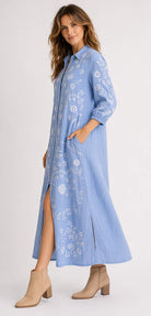 Feather Shirt Dress in soft chambray linen with floral embroidery, button-through front, ankle-length silhouette and side splits.
