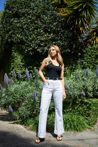 
The Jayne Wide Leg Jean in white features a flattering high waist, super-stretch denim, front patch pockets, and a wide stitched hem.