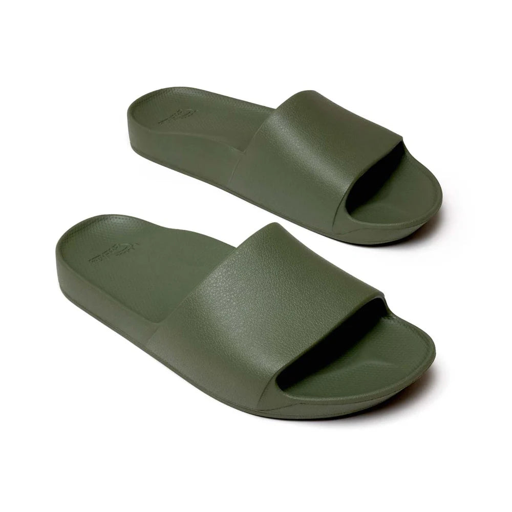 A pair of khaki-colored arch support slides with a contoured footbed designed for comfort. The slides feature a wide, cushioned strap and a thick sole for enhanced support and stability.