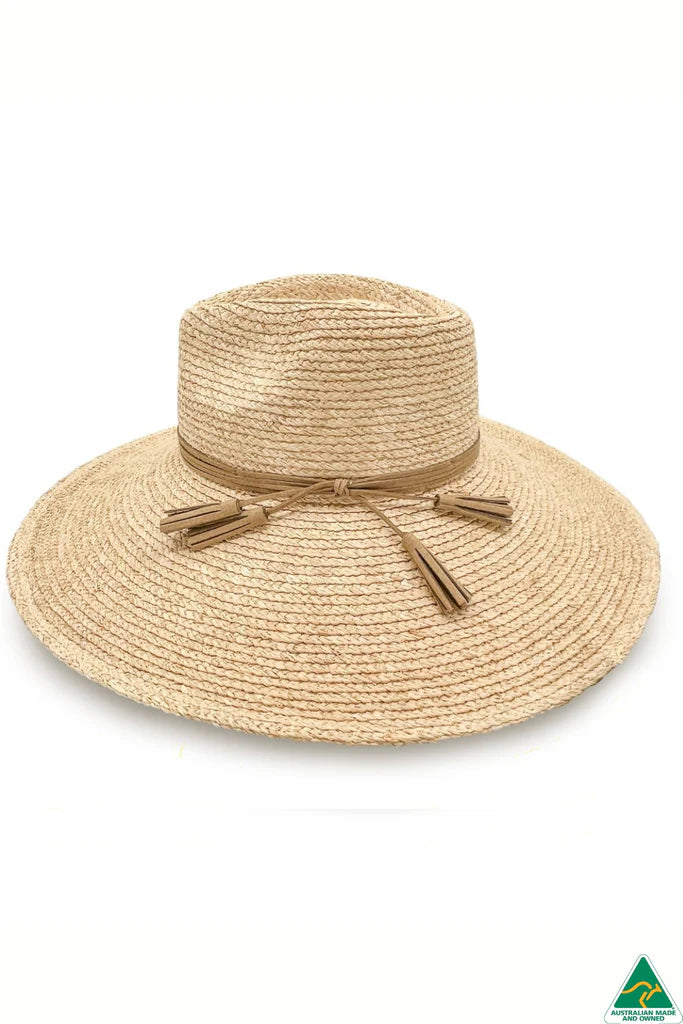Kimberley Raffia Fedora in natural with 13cm wide brim, 10cm crown, brown leather tassel trim, ComfyFit adjustable band, and removable chin strap.
