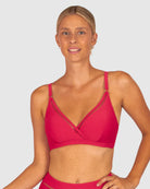 A woman modelling Baku Swim Wear in the Rococco D-E Cup Ladder Lace Wrap Bikini Bra Top in Cherry