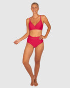 A woman modelling Baku Swim Wear in the Rococco D-E Cup Ladder Lace Wrap Bikini Bra Top in Cherry