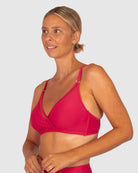 A woman modelling Baku Swim Wear in the Rococco D-E Cup Ladder Lace Wrap Bikini Bra Top in Cherry