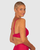 A woman modelling Baku Swim Wear in the Rococco D-E Cup Ladder Lace Wrap Bikini Bra Top in Cherry