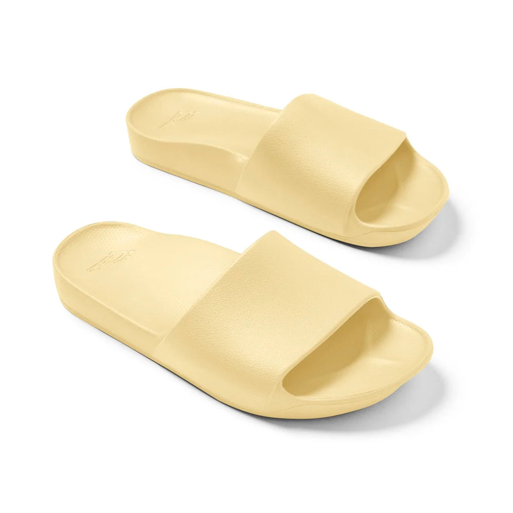 A pair of lemon-yellow arch support slides with a contoured footbed, thick cushioned soles, and an open-toe design, providing comfort and support for everyday wear.