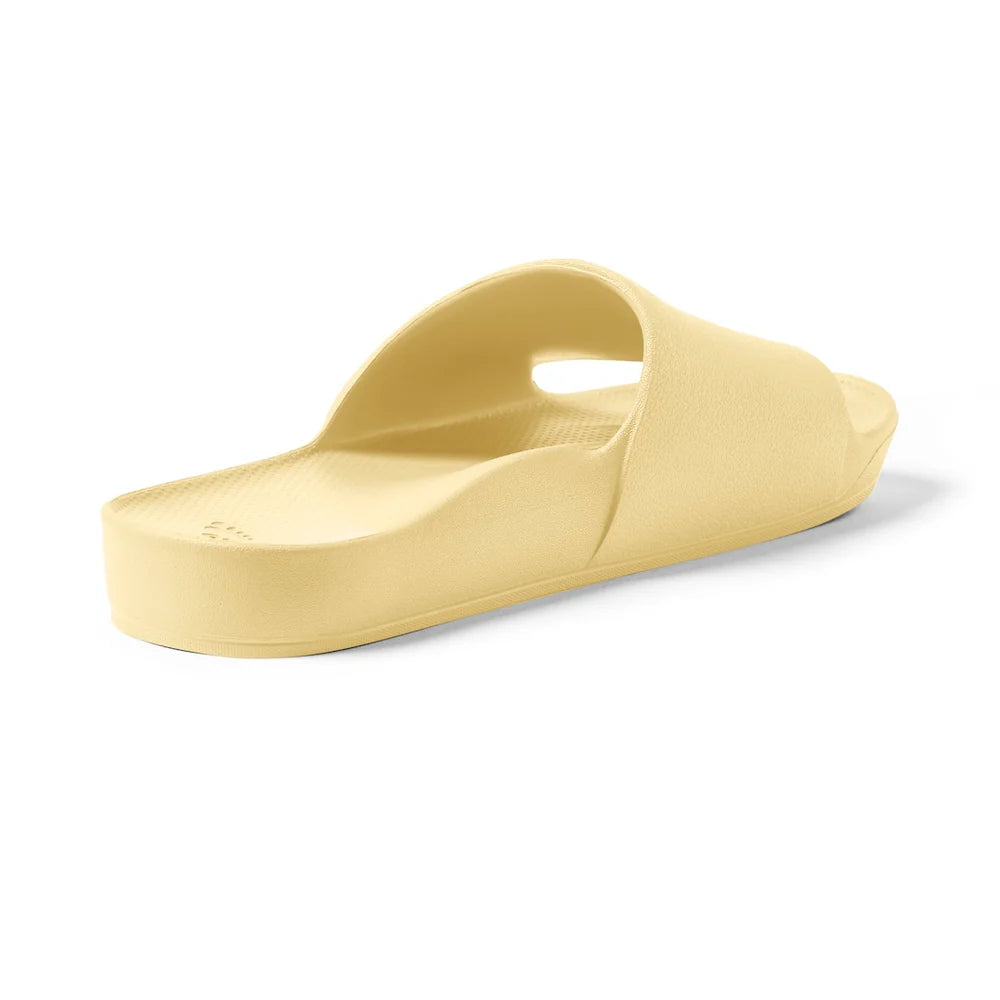 A pair of lemon-yellow arch support slides with a contoured footbed, thick cushioned soles, and an open-toe design, providing comfort and support for everyday wear.