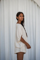 The Lily Pilly Tina Top in soft oatmeal linen is designed with a relaxed silhouette, lightweight feel, and natural textured weave.