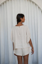 The Lily Pilly Tina Top in soft oatmeal linen is designed with a relaxed silhouette, lightweight feel, and natural textured weave.