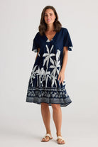 A woman modelling the Lola Knee Length Dress in Blue Haven by Holiday