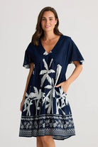 A woman modelling the Lola Knee Length Dress in Blue Haven by Holiday