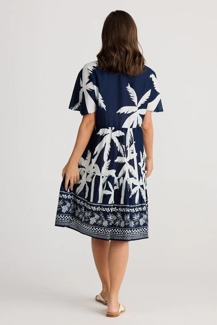 A woman modelling the Lola Knee Length Dress in Blue Haven by Holiday from behind