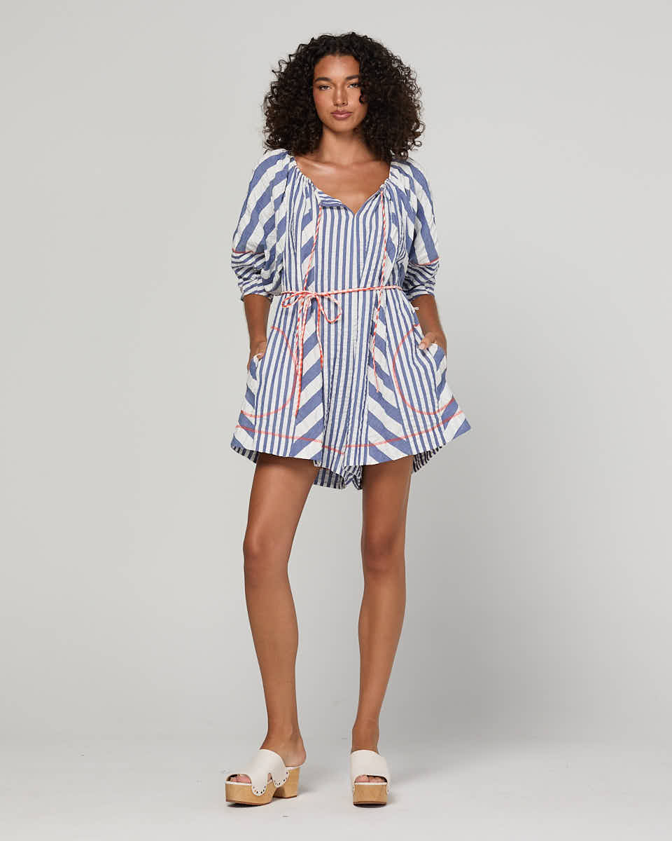 Boom Shankar Lucia Playsuit in Ocean Stripe with a tie neckline, balloon sleeves, contrast cuffs, gingham waist tie and relaxed fit.