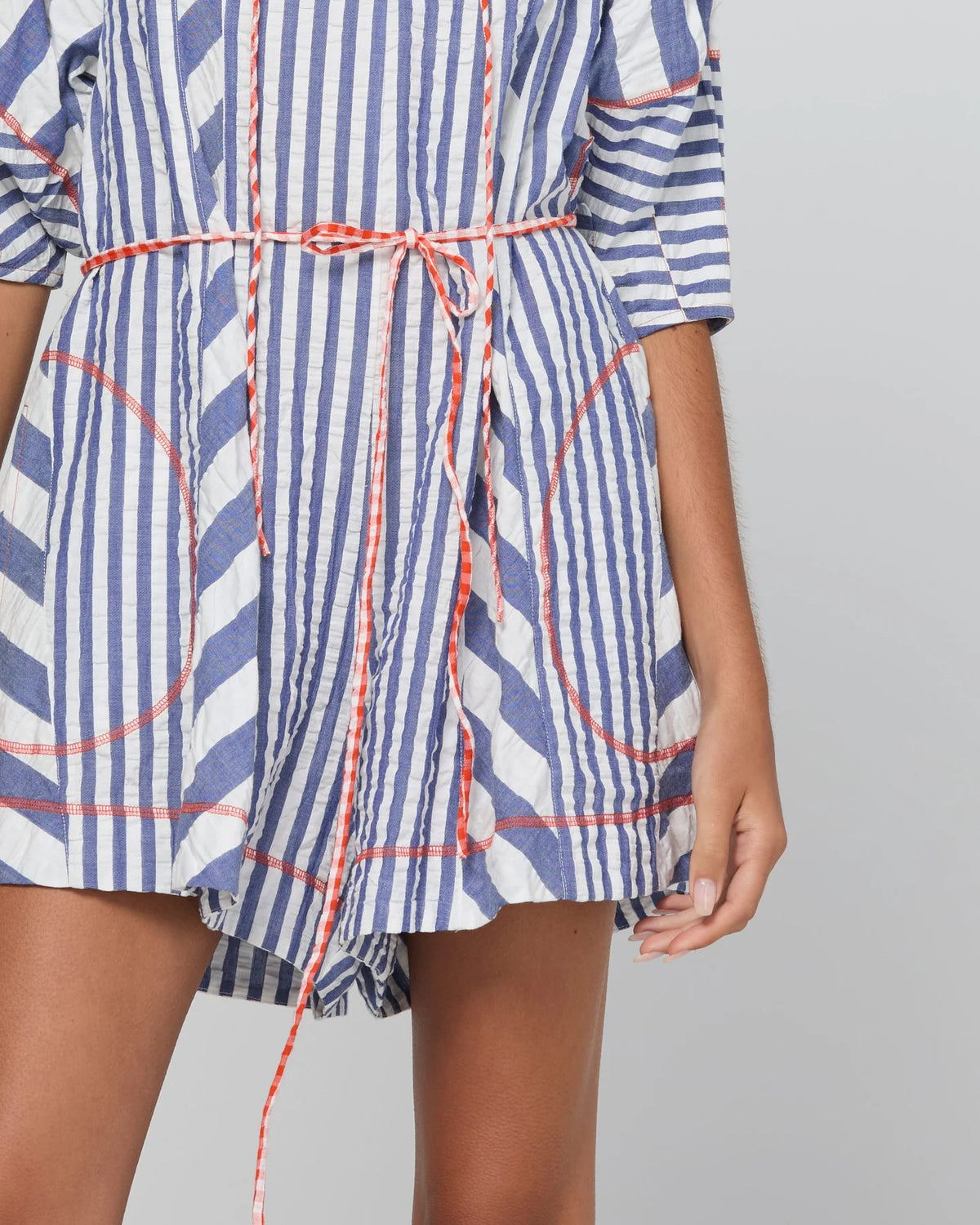 Boom Shankar Lucia Playsuit in Ocean Stripe with a tie neckline, balloon sleeves, contrast cuffs, gingham waist tie and relaxed fit.