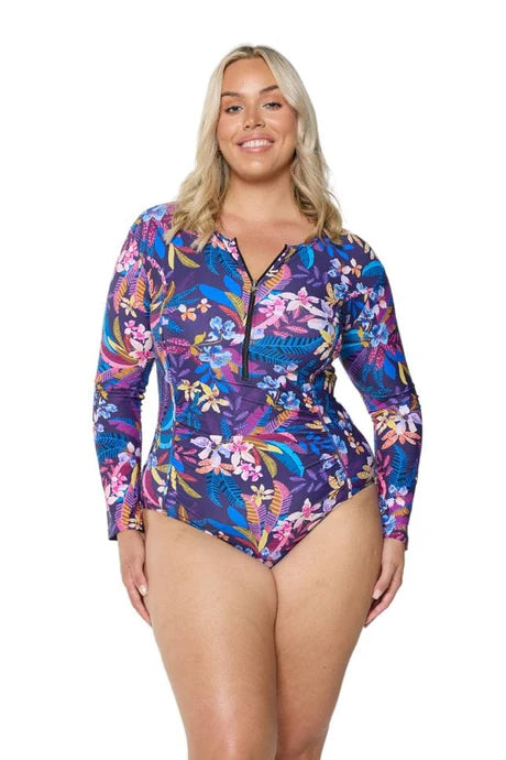 A tropical floral Majorca long sleeve one-piece swimsuit with a zippered neckline, flattering curve-enhancing fit, and rich inky blue base.