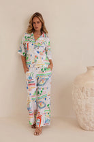 High-waisted wide-leg linen pants in vibrant Marrakesh print, featuring a breathable feel and flowing, relaxed silhouette.