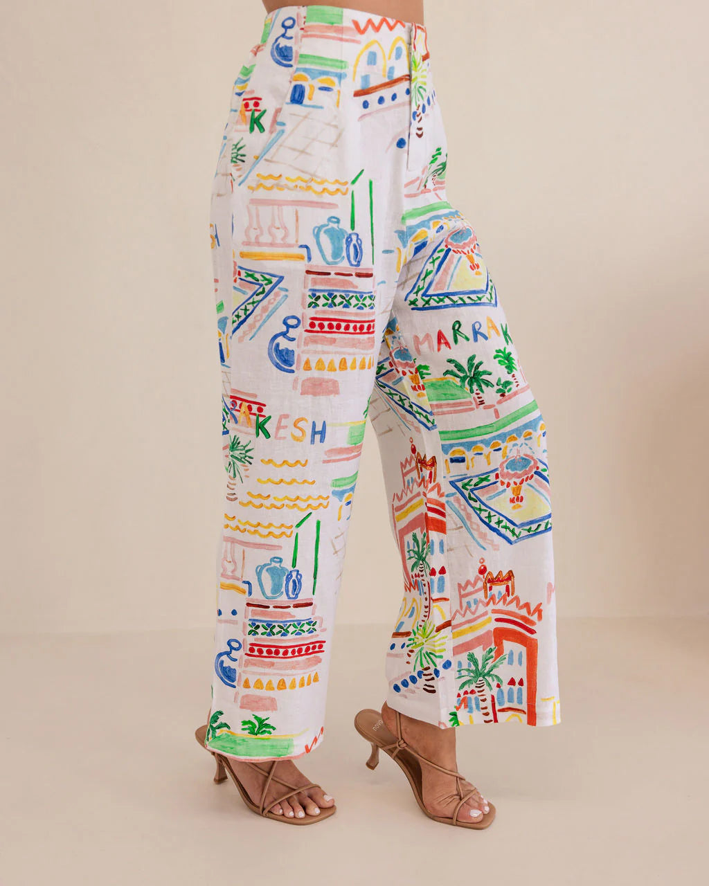 High-waisted wide-leg linen pants in vibrant Marrakesh print, featuring a breathable feel and flowing, relaxed silhouette.