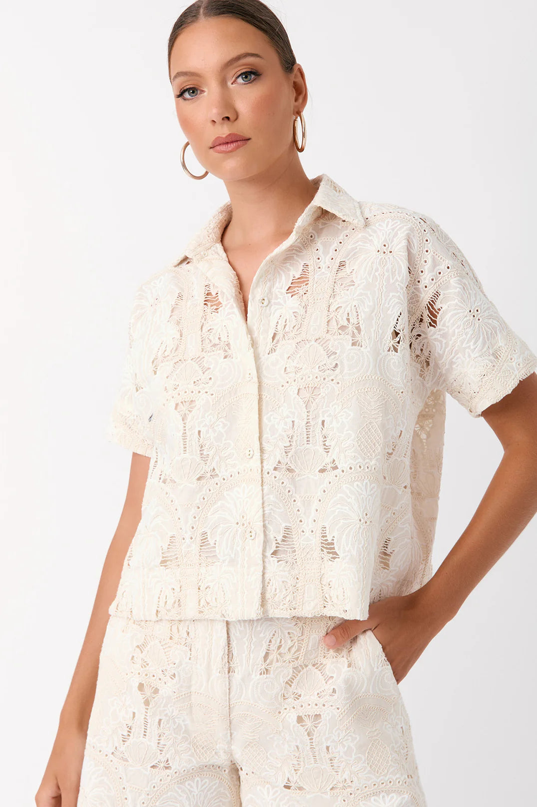 Breathe effortless elegance into your wardrobe with the Millie Paradiso Broderie Shirt. Designed with a classic collared neckline and button-through front, this versatile piece is perfect for any occasion.