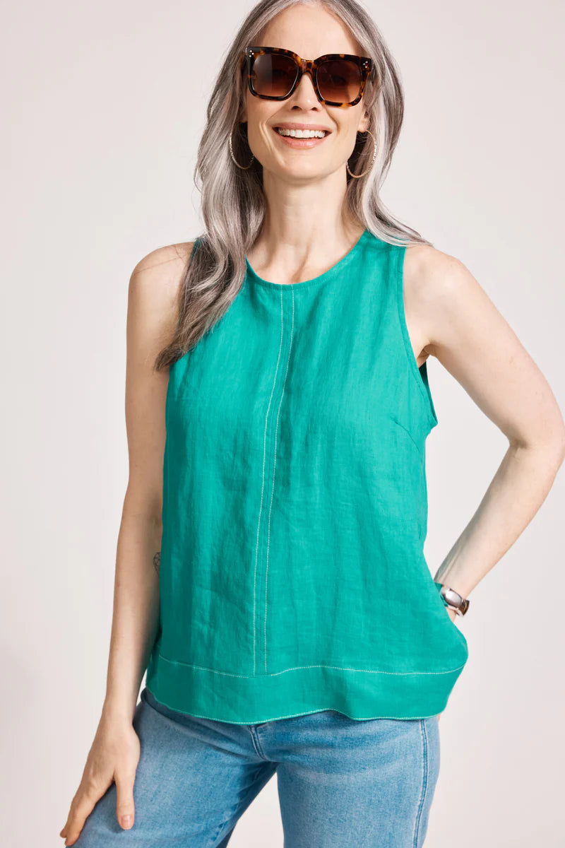 A relaxed, lagoon-coloured 100% linen tank top featuring exposed shoulders, contrast decorative topstitching, and a soft A-line silhouette. The design includes a wide cuffed hem and a button closure at the back neck, giving the lightweight, breathable top an effortlessly refined look