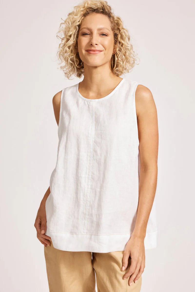 A relaxed, white 100% linen tank top featuring exposed shoulders, contrast decorative topstitching, and a soft A-line silhouette. The design includes a wide cuffed hem and a button closure at the back neck, giving the lightweight, breathable top an effortlessly refined look