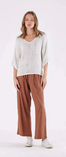 A natural and white handwoven cotton-rayon top with a V-neckline, 3/4 sleeves, and cotton binding, offering a breathable and stylish look.