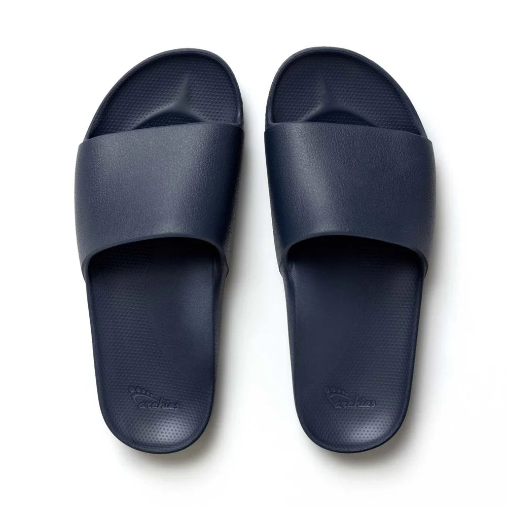 A pair of navy blue arch support slides with a contoured footbed, designed for comfort and stability. The slides feature a wide strap across the top and a cushioned sole for all-day wear.