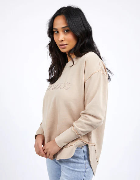 Foxwood Simplified Crew in oatmeal with round neck, raw edge details, and side splits for a relaxed, everyday look.