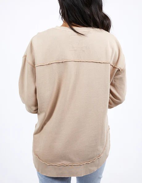 Foxwood Simplified Crew in oatmeal with round neck, raw edge details, and side splits for a relaxed, everyday look.