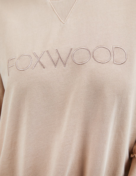 Foxwood Simplified Crew in oatmeal with round neck, raw edge details, and side splits for a relaxed, everyday look.