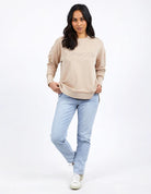 Foxwood Simplified Crew in oatmeal with round neck, raw edge details, and side splits for a relaxed, everyday look.