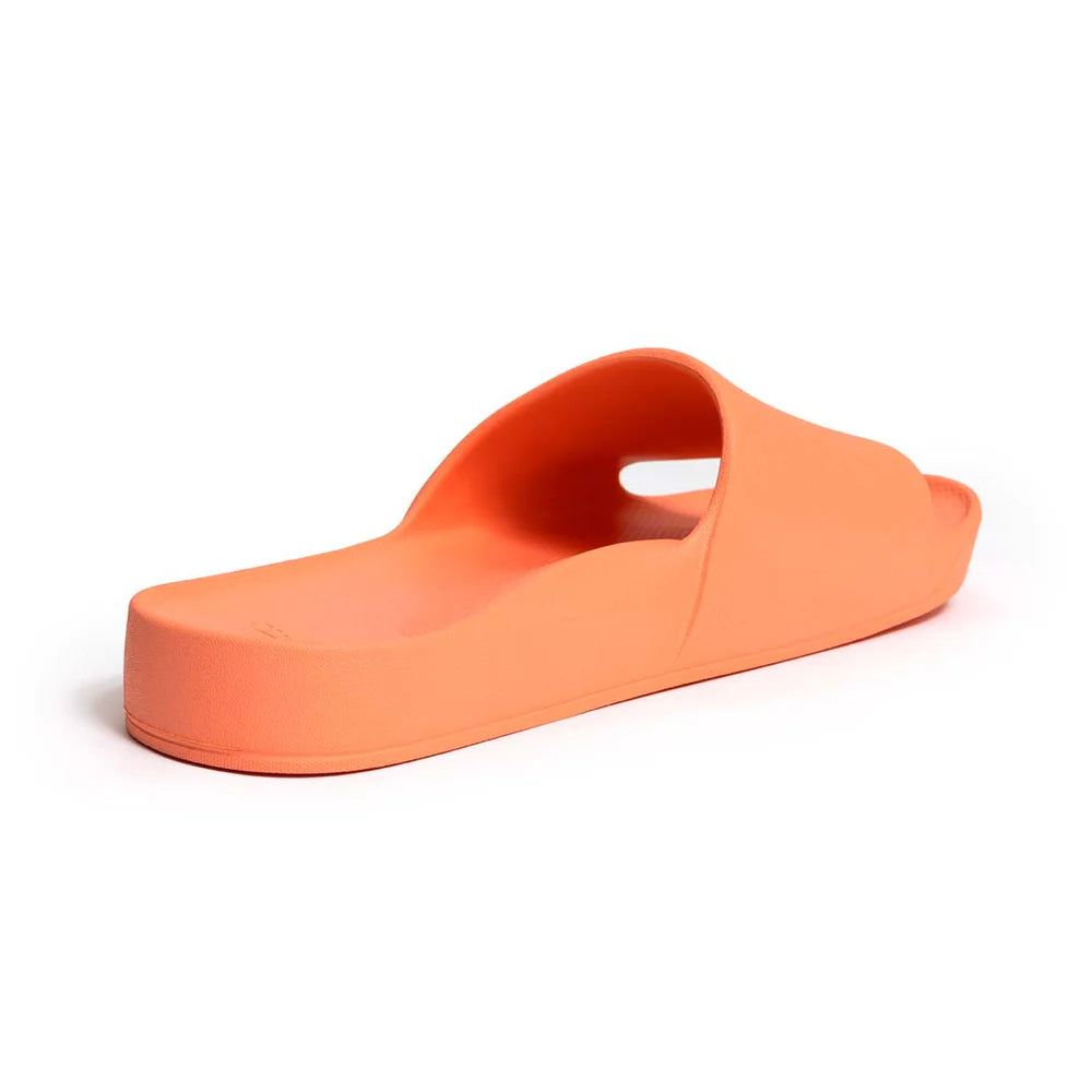 A pair of peach arch support slides with contoured footbeds and wide straps, designed for comfort and all-day wear.
