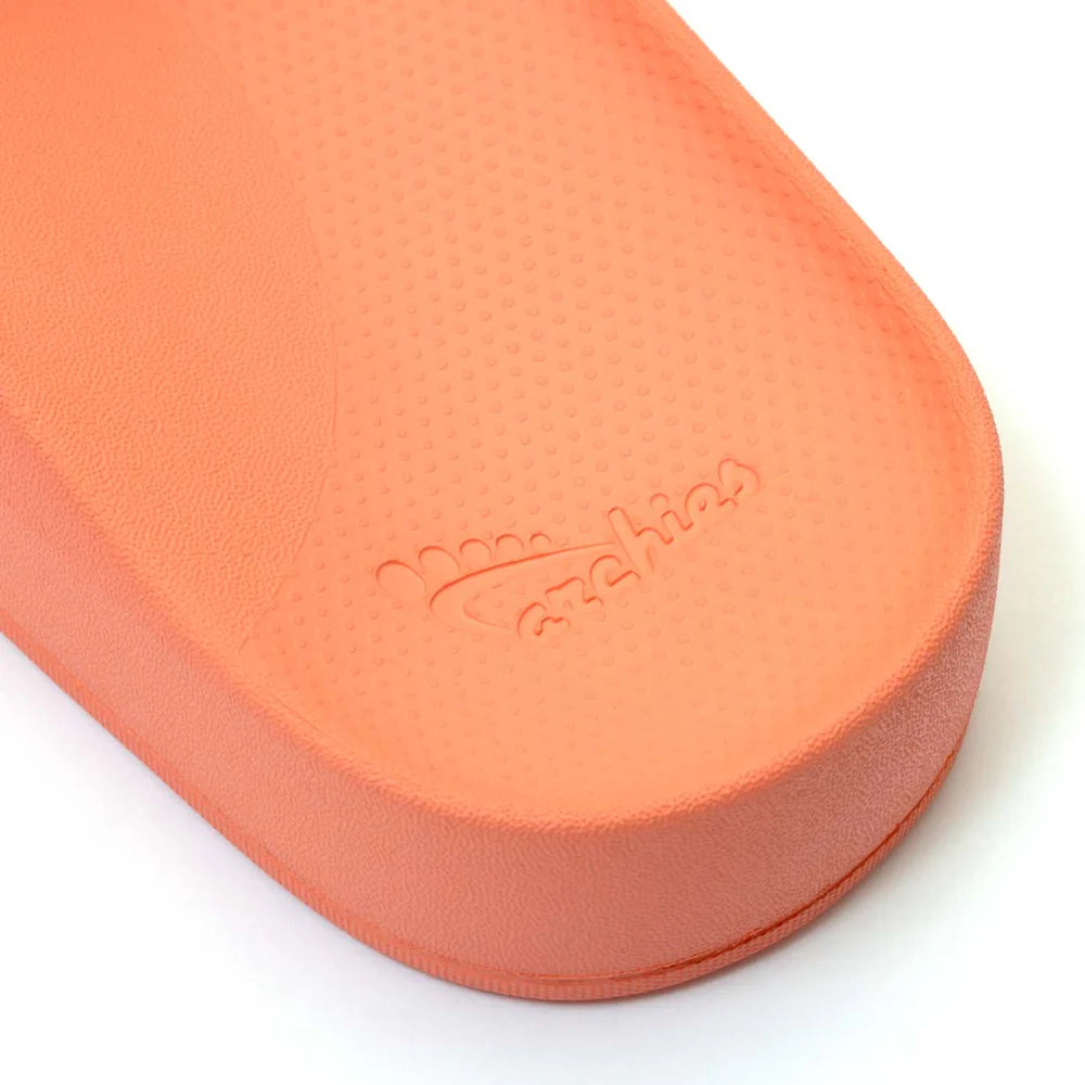A pair of peach arch support slides with contoured footbeds and wide straps, designed for comfort and all-day wear.