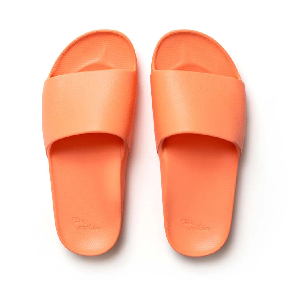 A pair of peach arch support slides with contoured footbeds and wide straps, designed for comfort and all-day wear.