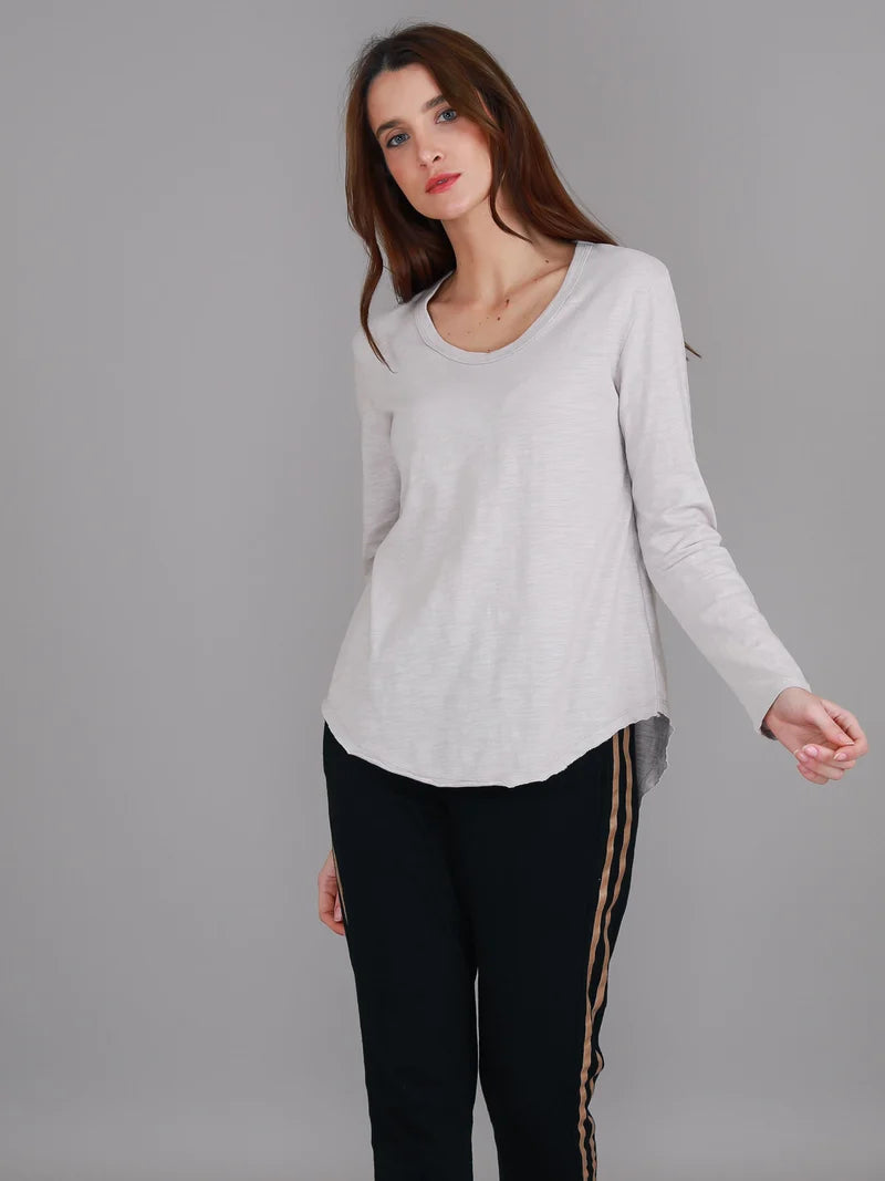 Angora Penola Long Sleeve T-Shirt featuring a crew neckline, relaxed full-length sleeves, straight silhouette and curved raw-edge hi-lo hem.