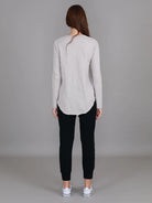 Angora Penola Long Sleeve T-Shirt featuring a crew neckline, relaxed full-length sleeves, straight silhouette and curved raw-edge hi-lo hem.