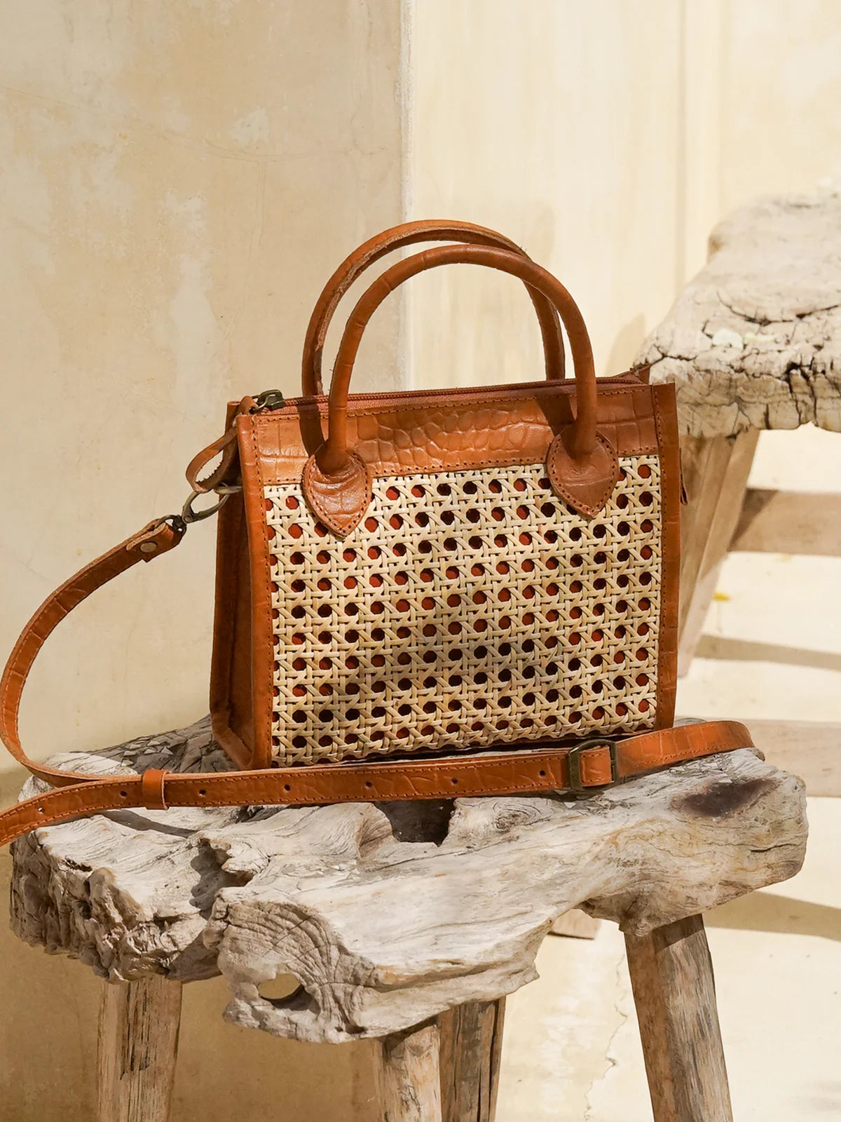 Prague Clutch in black and tan featuring natural rattan weaving with genuine leather accents in a sleek summer-ready design.