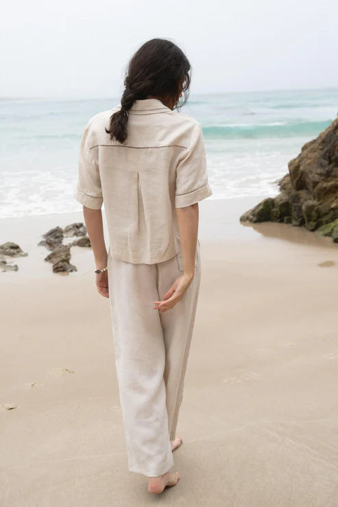 Quinn Linen Shirt in Chalk, featuring a relaxed, boxy fit, cotton lace inserts on the pocket, collar, and cuffs, and finished with French seams for a polished look.