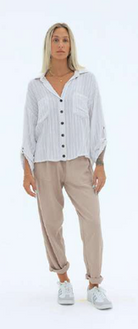 A natural-colored rayon-linen blend shirt with a relaxed silhouette and soft, lightweight drape. Designed with a minimalist look for easy styling, the top offers breathable comfort and effortless versatility for everyday wear