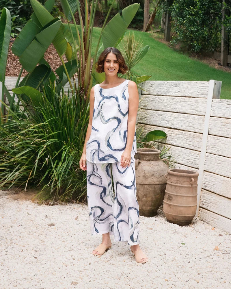 Palazzo linen pants featuring a relaxed wide-leg fit, high waist and shell button detailing down the side seam.