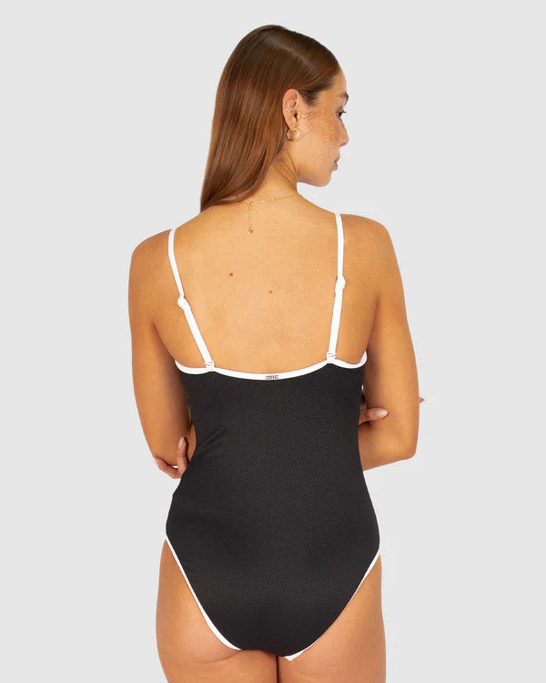 A sleek and sophisticated one-piece swimsuit in buttery-soft Rococco fabric, featuring a flattering V-neckline and structured shaping for a confident, elegant fit.