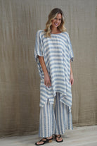 Rosa Elasticated Sleeves Kaftan in cornflower blue with white stripes, made from 100% plain and mesh linen. Features a relaxed silhouette, breathable fabric, and elasticated sleeves, evoking a sophisticated coastal vibe.