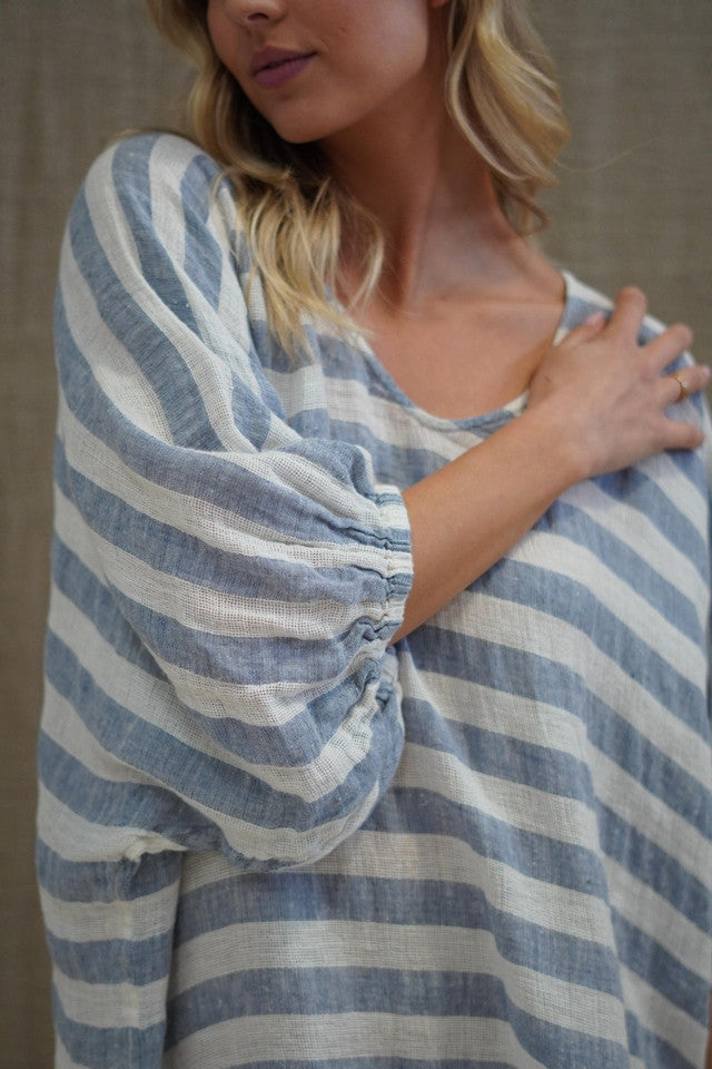 Rosa Elasticated Sleeves Kaftan in cornflower blue with white stripes, made from 100% plain and mesh linen. Features a relaxed silhouette, breathable fabric, and elasticated sleeves, evoking a sophisticated coastal vibe.